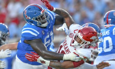 Arkansas Razorbacks linebacker Xavian Sorey takes a hard block from an Ole Miss Rebels offensive lineman